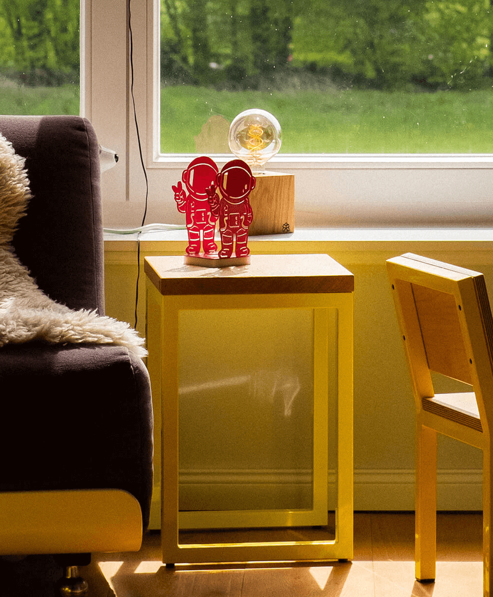 Windlicht aus Metall Astronaut-Motiv auf unserem Hocker TALON in einem Kinderzimmer